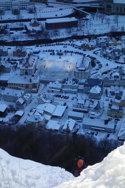 Veiw from half way up of Tjonnstadbergfossen, with Neil part way up the second pitch. Surreal illumination of the town square by sun mirrors on the mountainside!